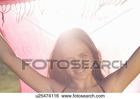 Teenage girl in braces holding sarong View Large Photo Image Stock Photograph - Teenage girl in braces holding sarong. Fotosearch