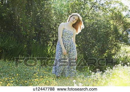 Teenage girl in field of flowers View Large Photo Image Stock Photo - Teenage girl in field of flowers. Fotosearch