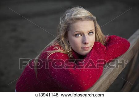 Teenage girl leaning on wooden fence View Large Photo Image Stock Photograph - Teenage girl leaning on wooden fence. Fotosearch