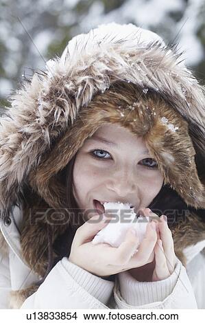 Teenage girl licking snowball View Large Photo Image Picture - Teenage girl licking snowball. Fotosearch