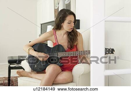 Teenage girl playing guitar View Large Photo Image Stock Photo - Teenage girl playing guitar. Fotosearch