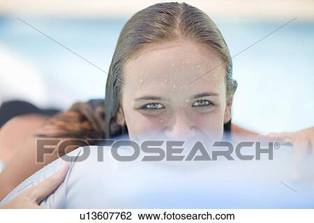 Teenage girl relaxing in pool View Large Photo Image Stock Image - Teenage girl relaxing in pool. Fotosearch