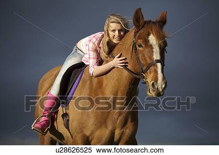 Stock Photography - Teenage girl riding horse outdoors. Fotosearch