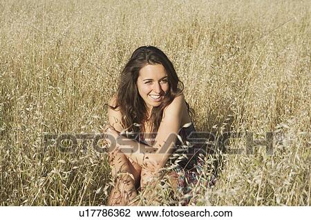 Teenage girl sitting in wheatfield View Large Photo Image Stock Image - Teenage girl sitting in wheatfield. Fotosearch