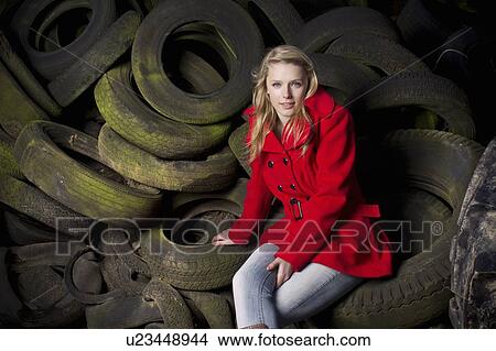 Teenage girl sitting on discarded tires View Large Photo Image Picture - Teenage girl sitting on discarded tires. Fotosearch