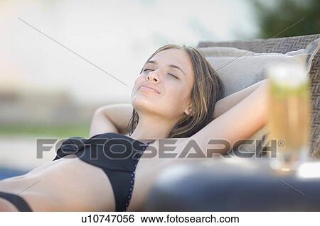 Stock Photograph - Teenage girl sleeping in lawn chair. Fotosearch