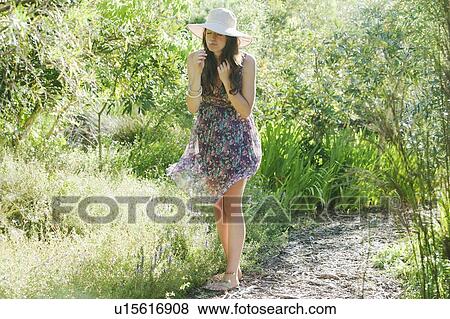 Teenage girl smelling flowers outdoors View Large Photo Image Stock Photo - Teenage girl smelling flowers outdoors. Fotosearch