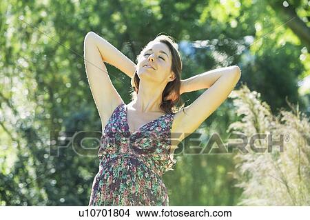 Teenage girl tossing her hair outdoors View Large Photo Image Picture - Teenage girl tossing her hair outdoors. Fotosearch