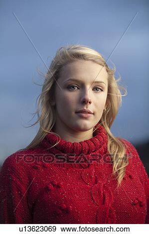 Stock Photo - Teenage girl wearing sweater outdoors. Fotosearch