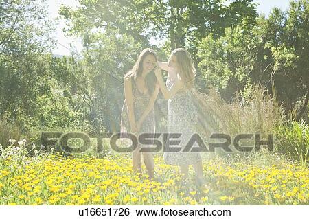Teenage girls in field of flowers View Large Photo Image Stock Photograph - Teenage girls in field of flowers. Fotosearch
