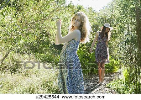 Picture - Teenage girls walking outdoors. Fotosearch