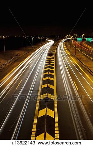 Stock Image - Time-lapse view of traffic on highway. Fotosearch