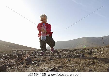 Toddler carrying bottle of water View Large Photo Image Stock Photography - Toddler carrying bottle of water. Fotosearch