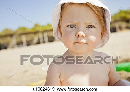Toddler frowning on beach View Large Photo Image Stock Photo - Toddler frowning on beach. Fotosearch