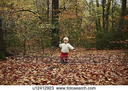 Toddler walking in autumn leaves View Large Photo Image Stock Image - Toddler walking in autumn leaves. Fotosearch