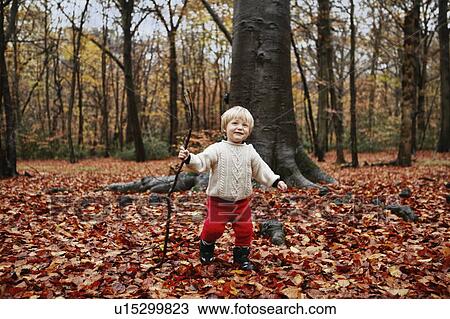 Toddler walking in autumn leaves View Large Photo Image Stock Image - Toddler walking in autumn leaves. Fotosearch