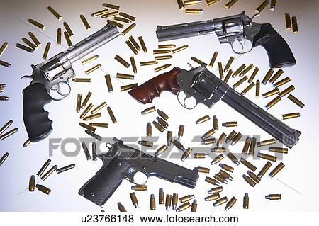 Stock Photo - Various handguns and bullets. Fotosearch