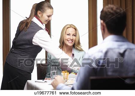 Waitress serving business people in cafe View Large Photo Image Stock Image - Waitress serving business people in cafe. Fotosearch