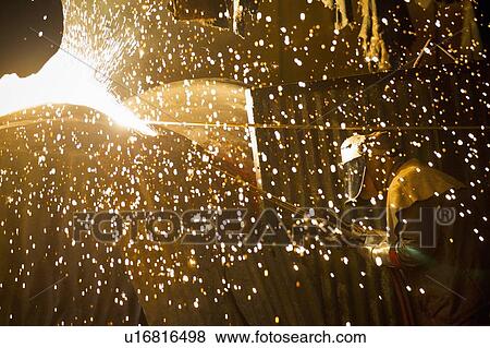 Stock Photo - Welder at work in steel forge. Fotosearch