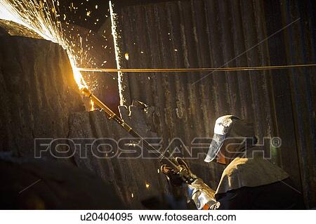 Stock Photography - Welder at work in steel forge. Fotosearch