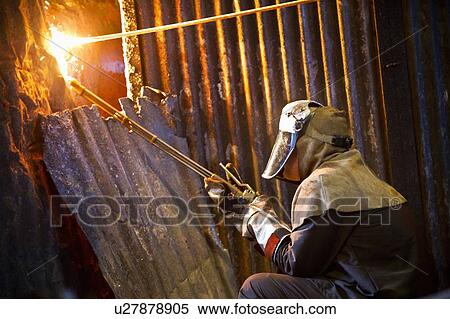 Stock Photography - Welder at work in steel forge. Fotosearch
