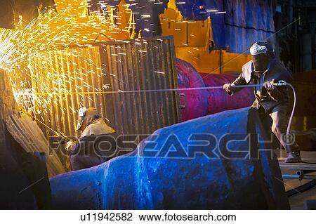 Welders at work in steel forge View Large Photo Image Stock Image - Welders at work in steel forge. Fotosearch