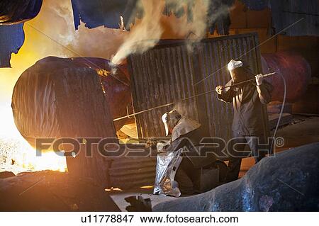 Stock Photo - Welders at work in steel forge. Fotosearch