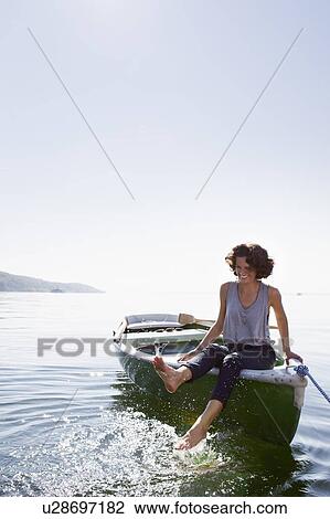 Woman dangling feet from boat in lake View Large Photo Image Stock Image - Woman dangling feet from boat in lake. Fotosearch