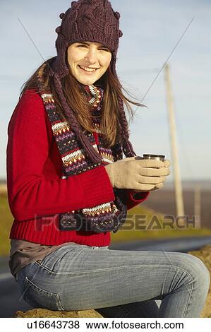 Stock Photo - Woman drinking coffee from thermos. Fotosearch