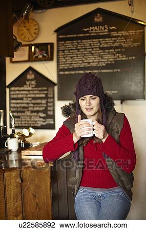 Woman drinking coffee in cafe View Large Photo Image Stock Image - Woman drinking coffee in cafe. Fotosearch