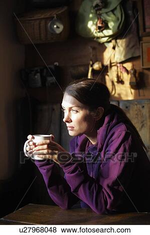 Woman drinking cup of coffee in cafe View Large Photo Image Stock Photo - Woman drinking cup of coffee in cafe. Fotosearch