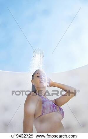 Woman in bikini showering outdoors View Large Photo Image Stock Photography - Woman in bikini showering outdoors. Fotosearch