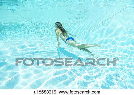 Woman in bikini swimming in pool View Large Photo Image Stock Photo - Woman in bikini swimming in pool. Fotosearch