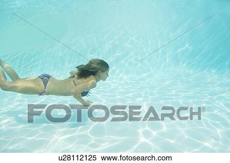 Woman in bikini swimming in pool View Large Photo Image Stock Photography - Woman in bikini swimming in pool. Fotosearch