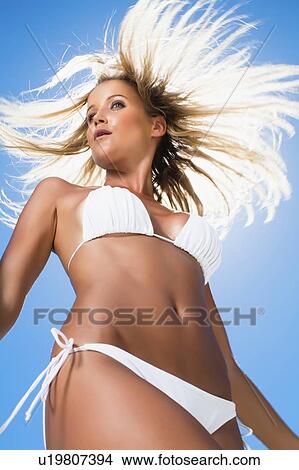 Picture - Woman in bikini tossing her hair. Fotosearch