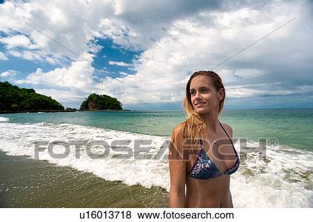 Woman in bikini walking in waves View Large Photo Image Stock Photo - Woman in bikini walking in waves. Fotosearch