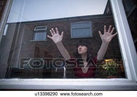 Woman in kitchen leaning on window View Large Photo Image Stock Image - Woman in kitchen leaning on window. Fotosearch