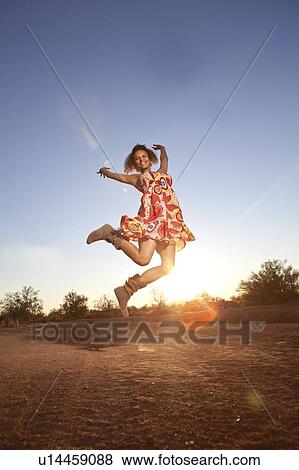 Woman jumping for joy in desert View Large Photo Image Stock Photo - Woman jumping for joy in desert. Fotosearch