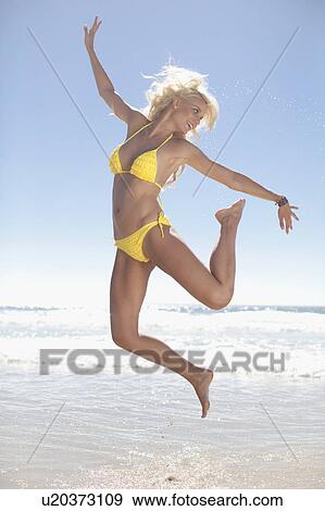 Woman jumping for joy on beach View Large Photo Image Stock Photo - Woman jumping for joy on beach. Fotosearch