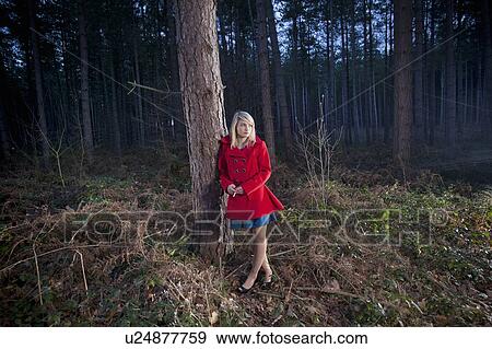 Woman leaning against tree in woods View Large Photo Image Stock Photo - Woman leaning against tree in woods. Fotosearch