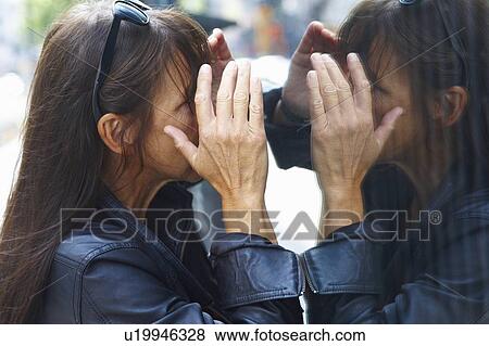 Woman peering through window View Large Photo Image Stock Photo - Woman peering through window. Fotosearch