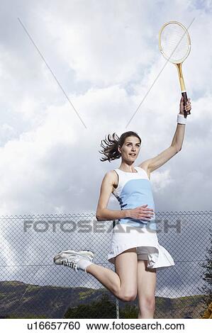 Woman playing tennis in outdoor court View Large Photo Image Stock Image - Woman playing tennis in outdoor court. Fotosearch