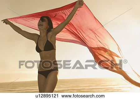 Woman playing with sarong on beach View Large Photo Image Stock Image - Woman playing with sarong on beach. Fotosearch