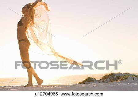 Woman playing with sarong on beach View Large Photo Image Stock Photography - Woman playing with sarong on beach. Fotosearch