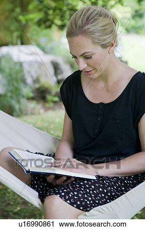 Woman reading book in hammock View Large Photo Image Stock Image - Woman reading book in hammock. Fotosearch