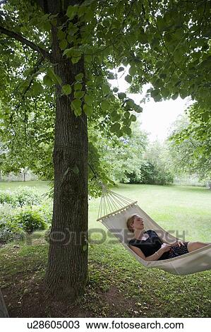 Woman relaxing in hammock View Large Photo Image Stock Image - Woman relaxing in hammock. Fotosearch