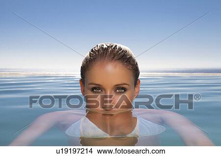 Woman relaxing in swimming pool View Large Photo Image Picture - Woman relaxing in swimming pool. Fotosearch