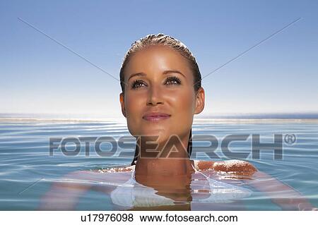Woman relaxing in swimming pool View Large Photo Image Stock Photo - Woman relaxing in swimming pool. Fotosearch