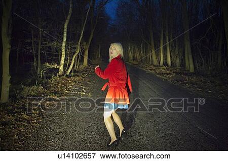 Woman running in fear in woods at night View Large Photo Image Stock Photo - Woman running in fear in woods at night. Fotosearch