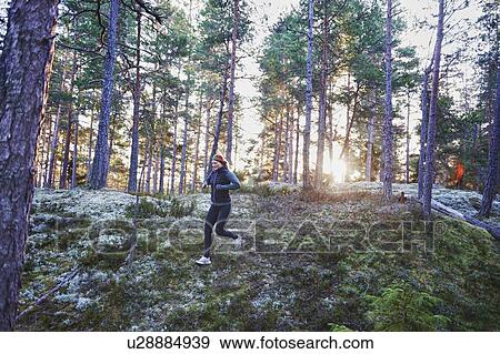 Woman running in forest View Large Photo Image Stock Photo - Woman running in forest. Fotosearch